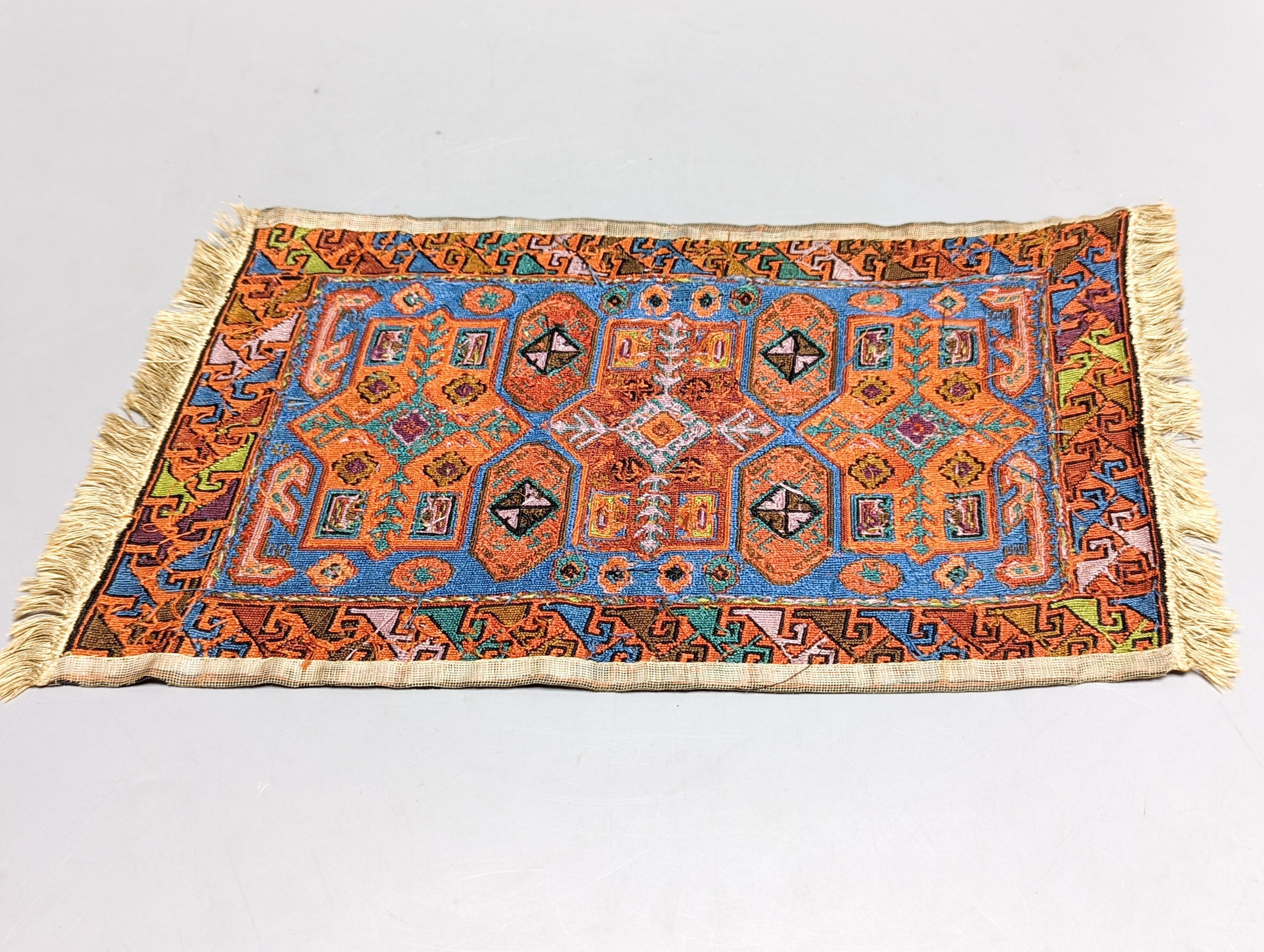 A Caucasian style petit point miniature rug 33x20cm